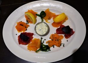 Salmon four-ways, Bradan Orach, Gin-cured, Beetroot-cured with pickled cucumber, roasted beetroot, crème fraîche, chives, baby capers